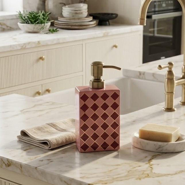 Harlequin enamel and brass multi-use bottle in Raspberry Pink on a kitchen worktop