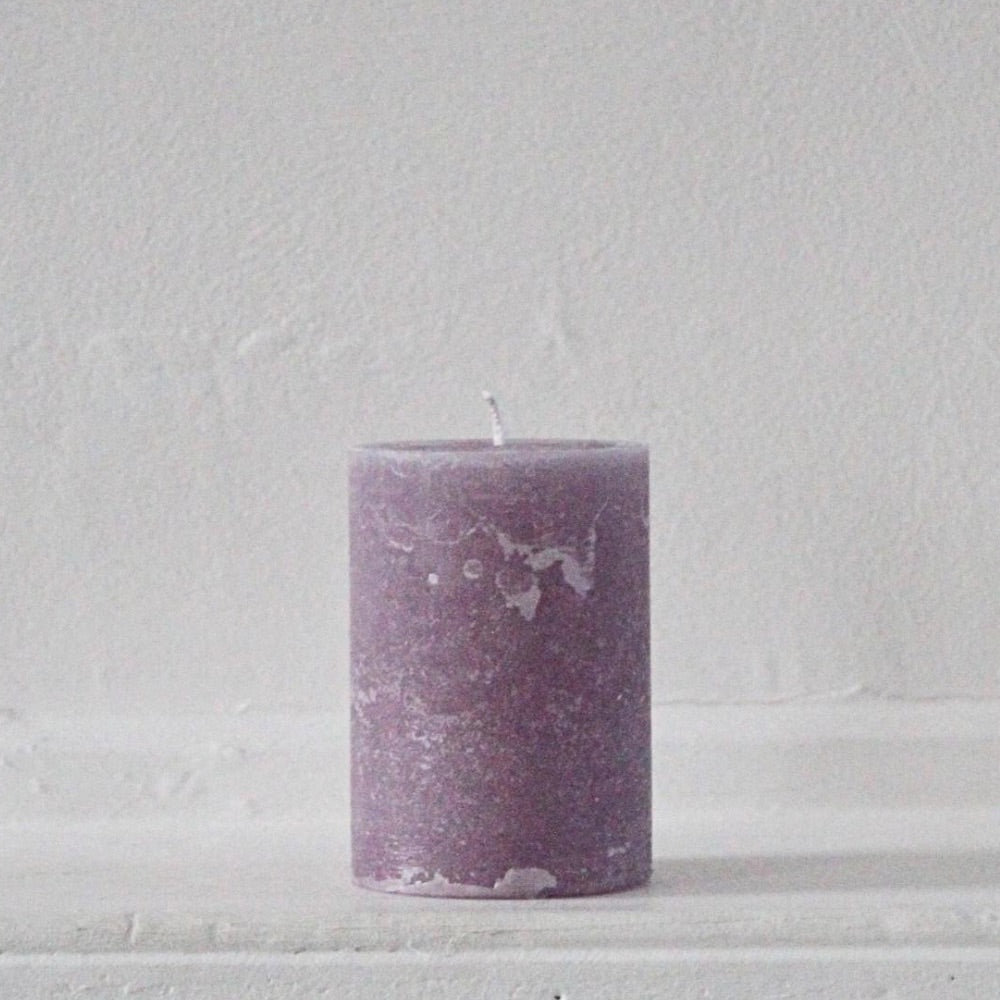 Rustic pillar candle in purple