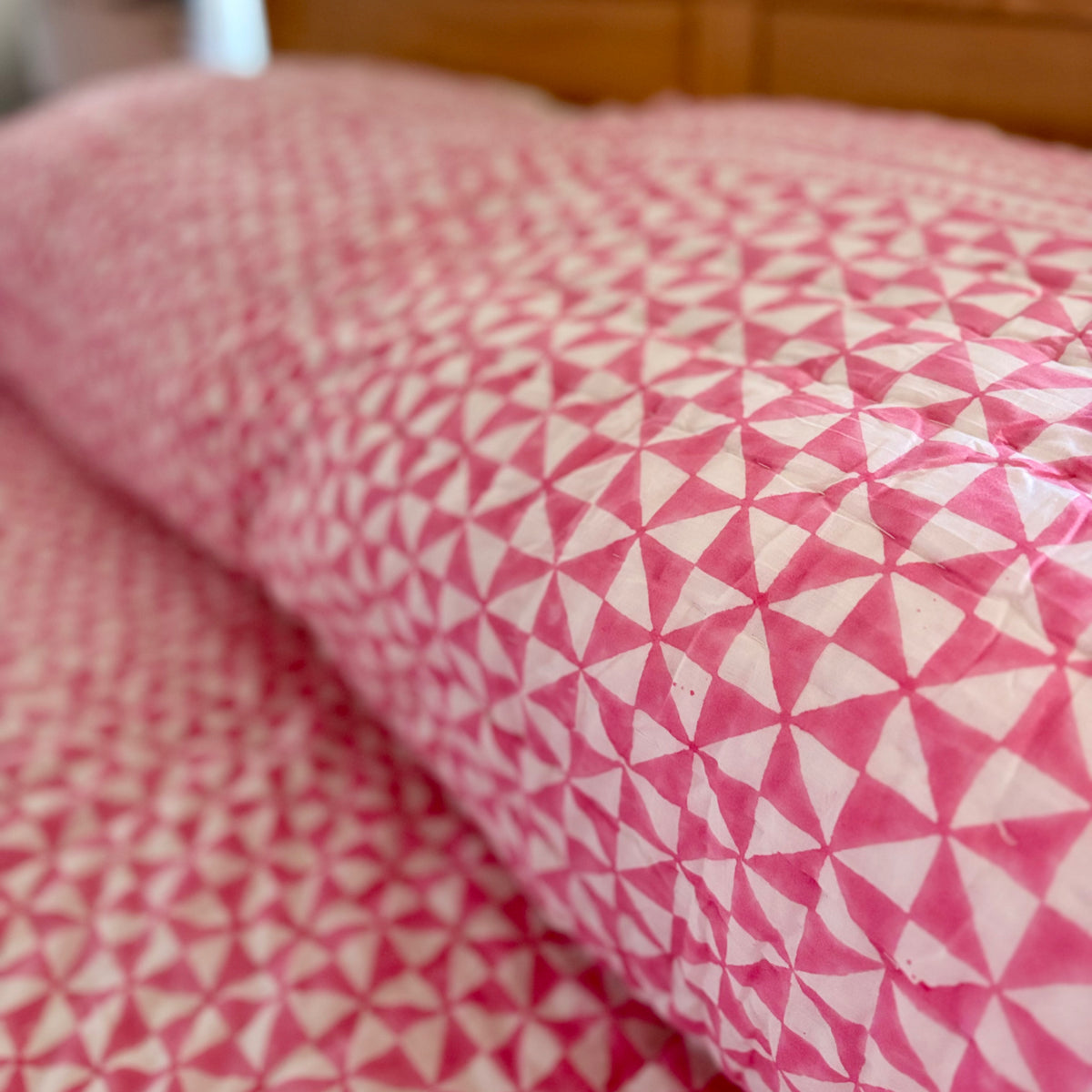 Harlequin reversible cotton quilt in Raspberry Pink, close-up of the print